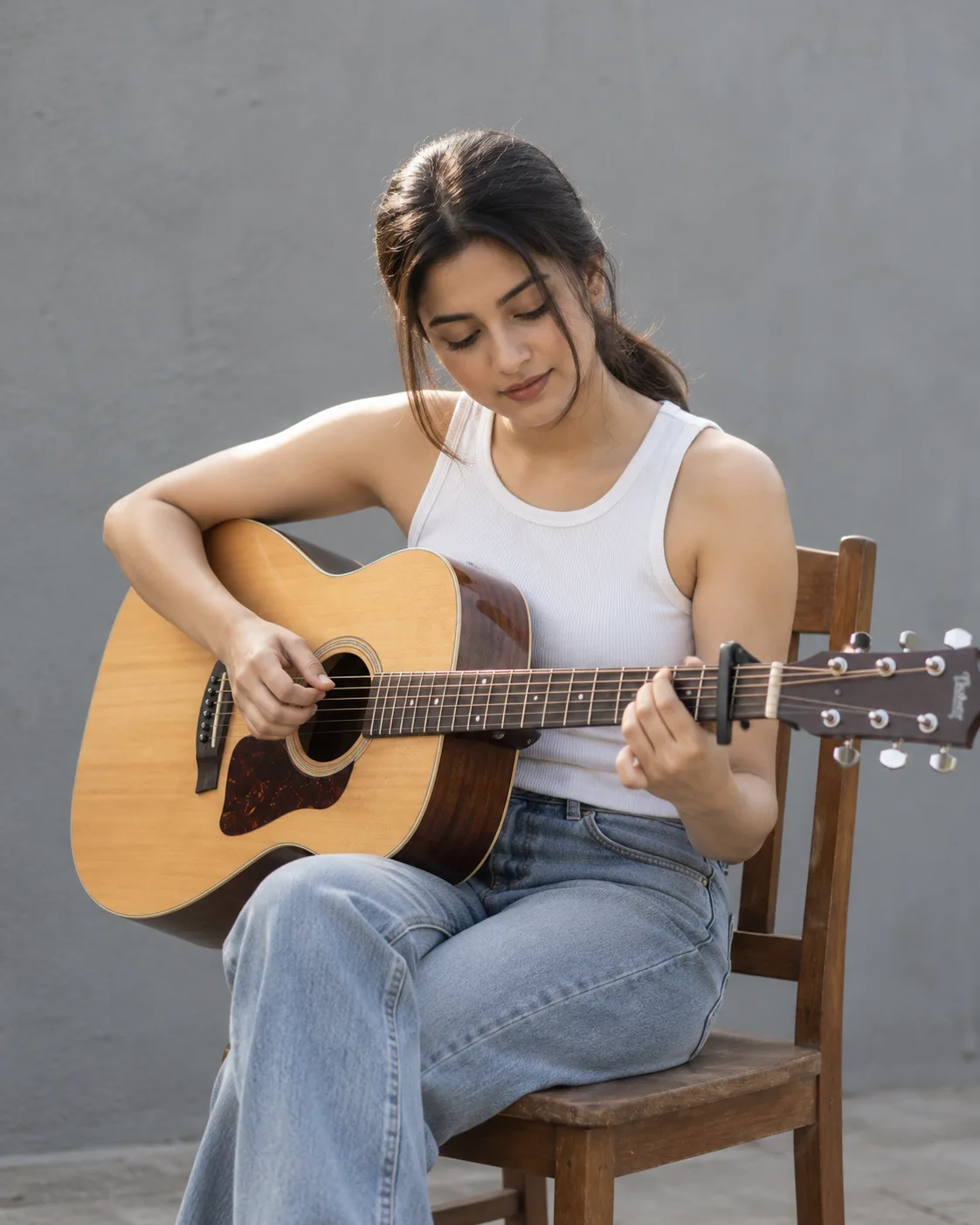 Musician Portrait AI Prompt showing a woman playing acoustic guitar outdoors