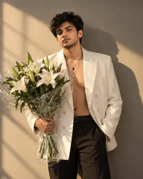 Luxury Man Portrait AI Prompt showing a man in an ivory blazer holding white lilies under warm golden sunlight